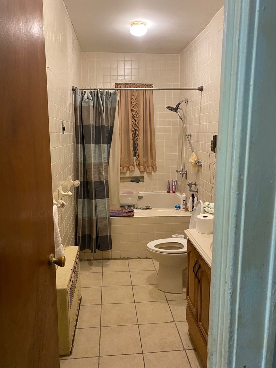 Bathroom before: old tub with a shower curtain